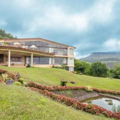 StayVista's Glass House - Villa with scenic lawn and mountain views