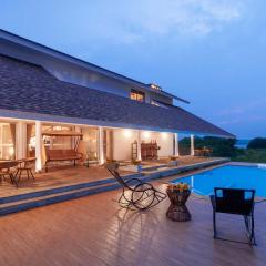 StayVista's Eva Villa - Lakeside Luxury with Modern Decor, Pool & Expansive Lawn - Near Sula