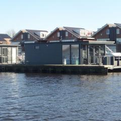 Modern houseboat with air conditioning located in marina