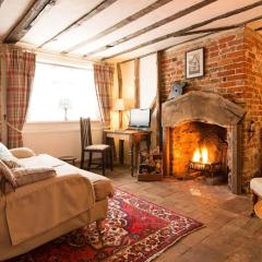 Spadgers, a flax workers cottage next to fields in a Medieval Village