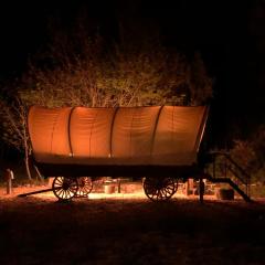 Cozy Wild West Covered Wagon next to River