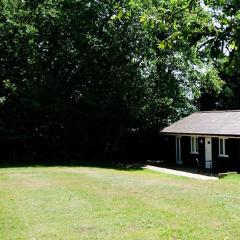 Cottage surrounded by woodland and vineyards.