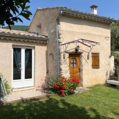 Cabanon entouré de montagnes et d'oliviers