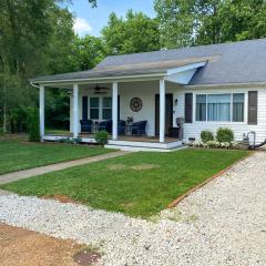 Quaint Creekside Cottage with Porch and Backyard!