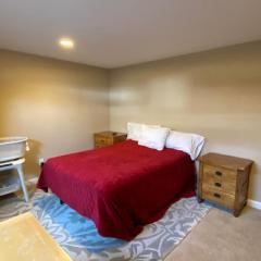 Private basement bedroom with private bathroom, kitchen, and living room with large screen television