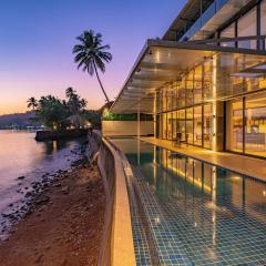 Oceanic Sunsets with River View, Comp Breakfast & Infinity Pool at StayVista