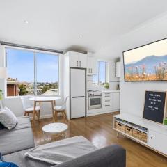 Top level one bedroom apartment with MCG views