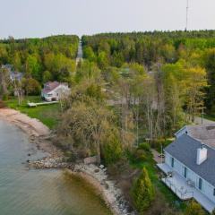 Lakefront De Tour Village Home with Deck and Fire Pit!