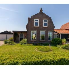 characteristic house in a rural location in the village of Zuidzande with garden