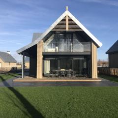 Modern design lodge directly at the water, in national park