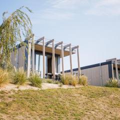 Chalet with a view of the beach or harbour, in a holiday park on the Leukermeer