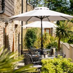 Corn Barn at East Trenean Farm -Luxury Cornish Barn Conversion sleeping 8 with hot tub, private garden, rural views and EV facilities