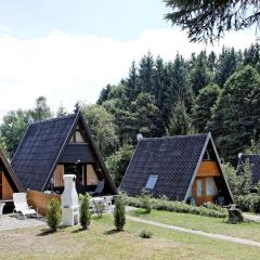 Wooden chalet with terrace near a swimming lake