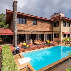 StayVista's Woodstone Villa - Mountain Retreat with Heated Pool & Activities