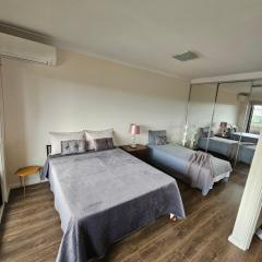 Book a Spacious room with a balcony for your stay with shared bathroom laundry kitchen and living area