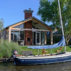 Modern bungalow with an outdoor fireplace by the water