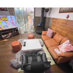 Tatami room & Living Room equipped with Multinational TV and Fire, BBQ corner in Tokyo Downtown House