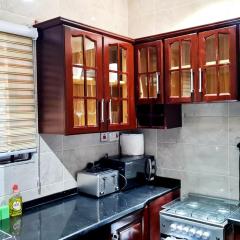 Elegant Escape in Adenta- 2-Bed, 5star Service, Free Wifi, 24-7 Security, Close to Highway, by DLA