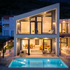 Three-bedroom Villa Sunshine with a heated pool, media room, and views of the sea