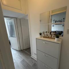 Bright bedroom with king side bed and share bathroom