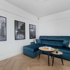 Blue and White Apartment in Łódź with Furnished Balcony by Noclegi Renters