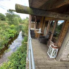 5 Star Country Retreat, huge Log Cabin over small river, with private hot tub & log burner, WiFi, 65 inch smart TV relax read at Weston Newark, Nottinghamshire