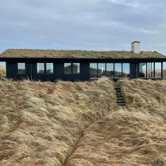 Wooden House In The Dunes Close To The Sea