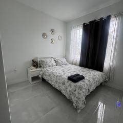 Modern room with kitchen and backyard access