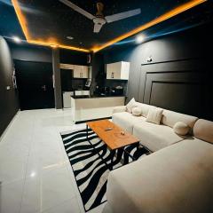 Dark Cozy 1BHK Sleep under the Stars Indoors with Swimming pool Gym and Cinema