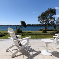 Sunset Sanctuary: Waterfront Home with Balcony and Patio