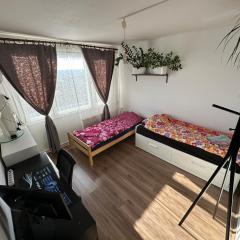 Private rooms, stunning city views, top-floor with balcony, bathtub, Internet, coffee