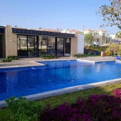House A in a residential condominium with a pool