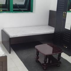 A bedroom with three beds for men only