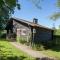 Open wooden chalet built against a hill