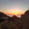 Villa La Lecceta surrounded by greenery and sea view with sunset
