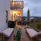 Earthy Ground Floor Home with Patio Sunbeds Greenery
