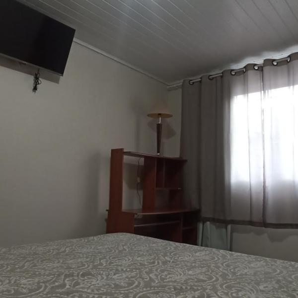 Quarto com escrivaninha e tv