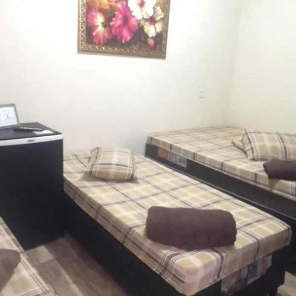 Quarto privativo para 4 pessoas com 1 cama de casal e 2 solteiros, hotel in Aparecida