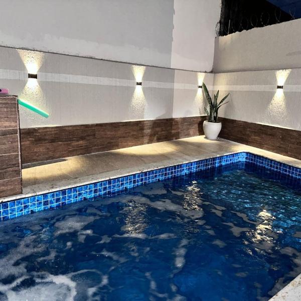 A Casa de Praia com ar, piscina aquecida e churrasqueira
