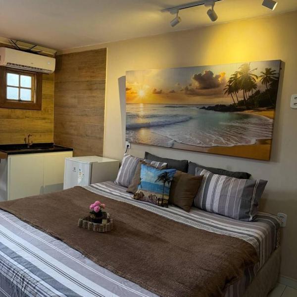 Suíte 27 com ar-condicionado, TV, frigobar e vista para o mar na Central Praias