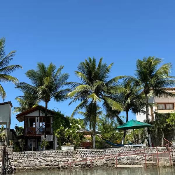 Casinha de madeira entre rio e mar